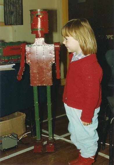 My daughter, Emma (aged 4), stands up to a walking robot built by visitor Roger Marriott at the 1990 exhibition