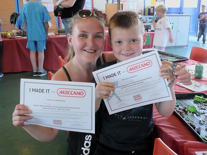 Two satisfied Make It With Meccano workshop participants show off their certificates