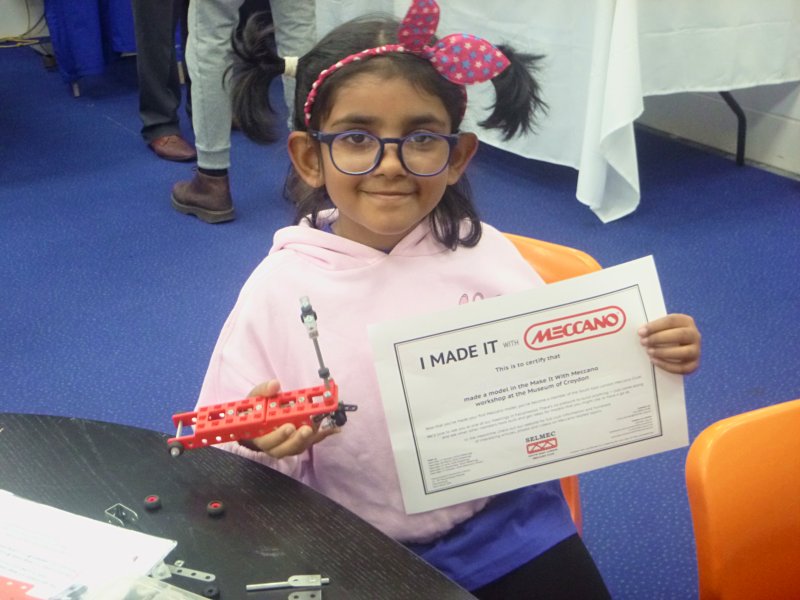 One of our Make It With Meccano workshop participants with her model and certificate