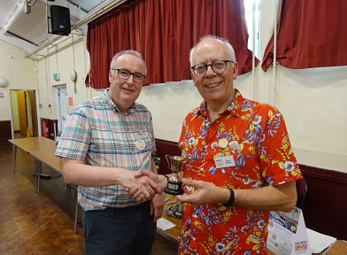 Brian Leach (left) awards the Cup to Chris Warrell